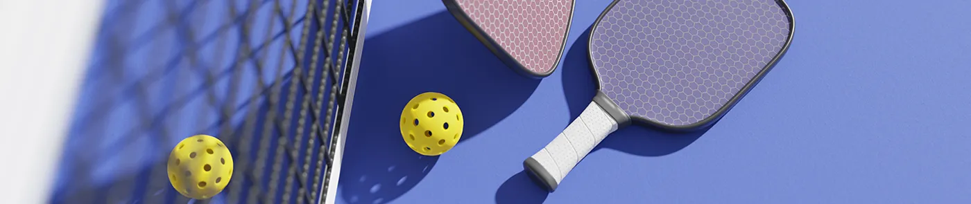 pickleball paddles balls and net on blue background