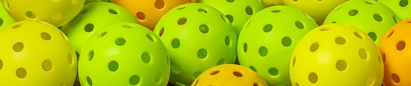 pile of colorful pickleballs